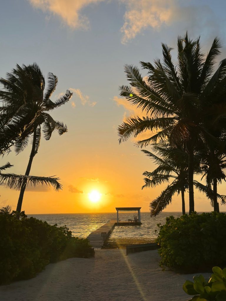 belize sunrise over dock and Caribbean sea