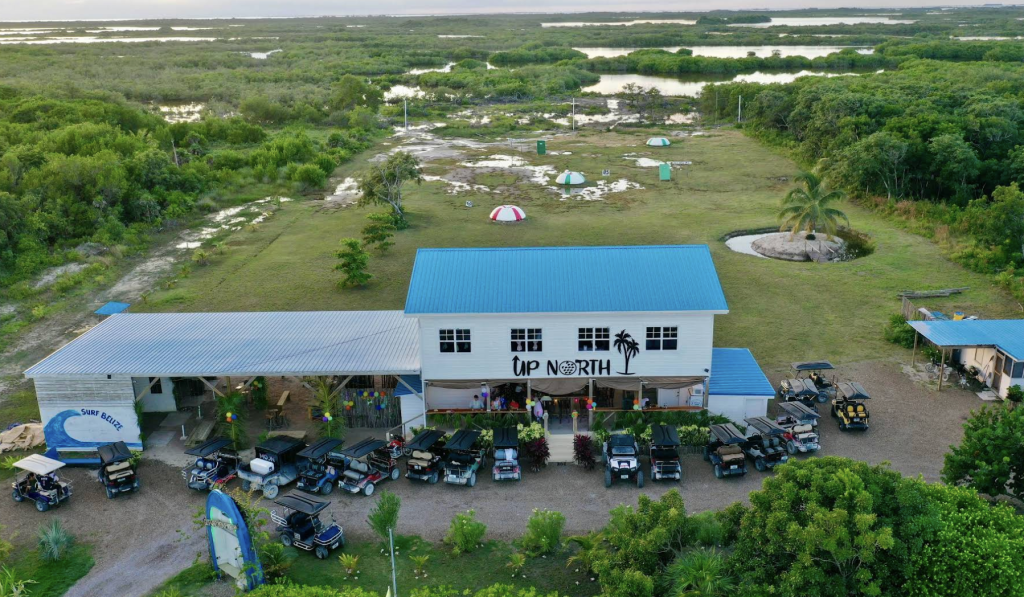Up North restaurant lunch menu listing local favorites like fairway fajitas, Belizean burrito, and fish and chips, alongside burgers, sandwiches, and a kids' menu, with prices in BZ dollars.